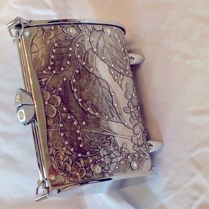 Silver tone metal evening bag with embossed floral designs